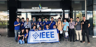 The students and lecturers pose for a group photo outside the Sarawak Energy headquarters.