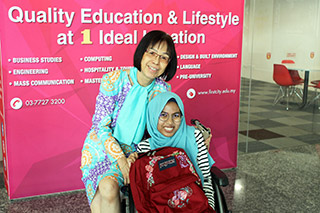 First City UC’s Chief Operating Officer Ms Yeong  Yin Cheng together with graduate Ainaa Farhanah Amali. Ainaa is showcasing the backpack that she has designed for Jansport X FCUC Bag Design Competition.