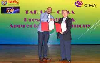 Mr Venkatt Ramanan (left) and Datuk Dr Tan Chik Heok, holding up the signed MoUs.
