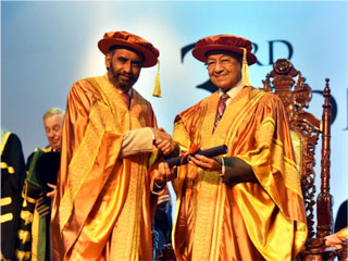 Tun Dr. Mahathir Mohamad receiving the Honorary Doctor of Philosophy Degree for Global Peace and National Reconciliation from Tan Sri Datuk Dr. Mohan Swami, Pro-Chancellor of Perdana University (Picture credit: Jabatan Penerangan Malaysia)