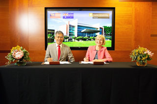 Datu Ose Murang and Professor Deborah Terry signing the JVA.